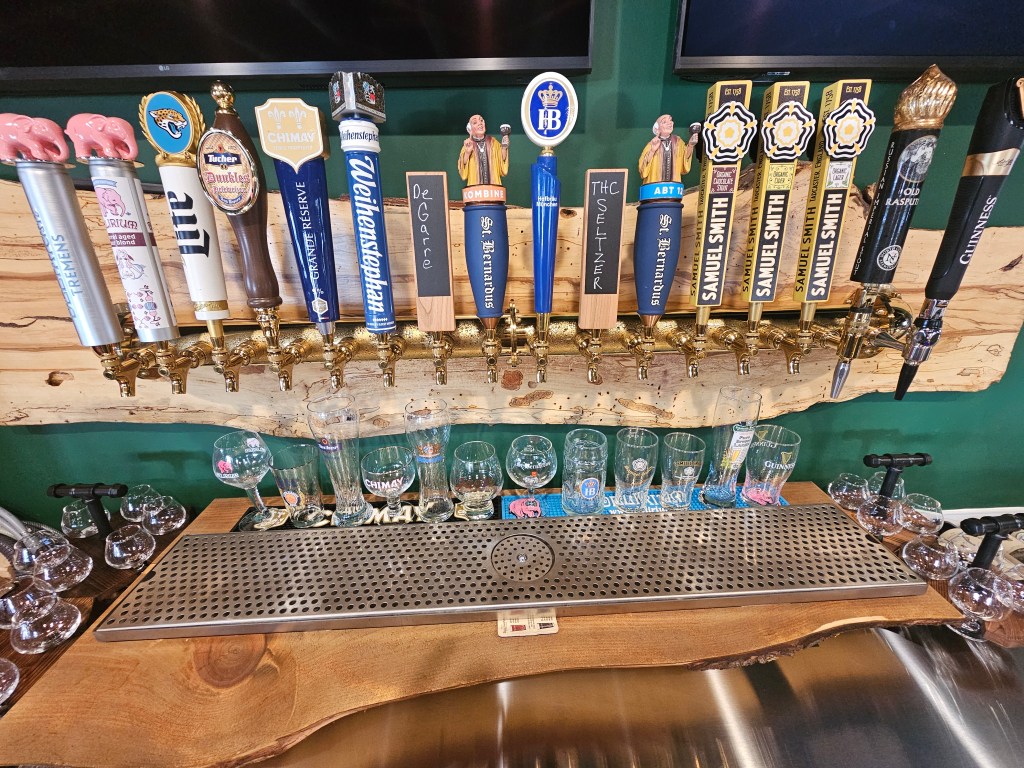 Bottles and glasses lined up along the bar